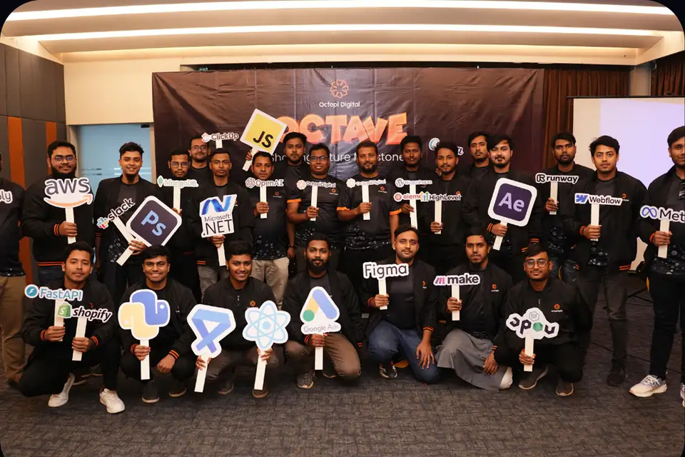 The Octopi team at an event holding Photoshop, After Effects and other tool signs